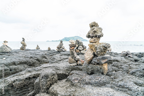 stone towers on basaltic rocks at Hyeopjae Beach,Jeju Island © topntp