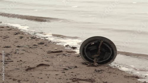 World War era Brodie helmet on beach