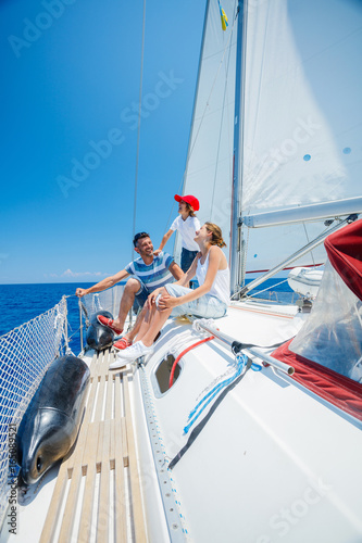 Father with adorable kids resting on yacht