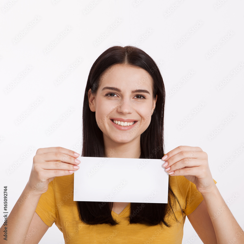 Your text here. Pretty young woman holding empty blank board. Studio portrait on white background. Mockup for design Your text here. Pretty young woman holding empty blank board. Studio portrait on white background. Mockup for design