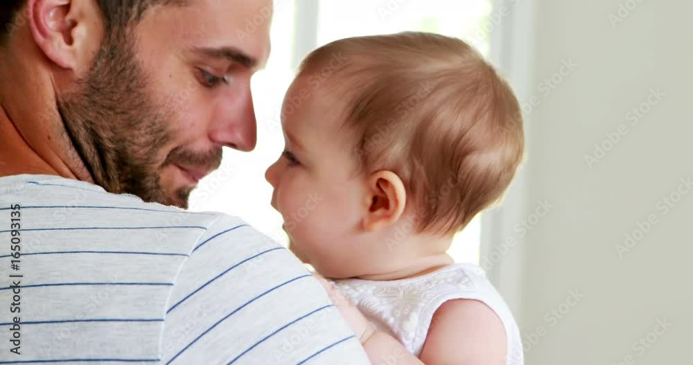 Father kissing his baby girl on forehead Father kissing his baby girl on forehead