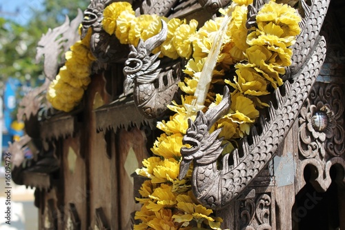 buddha statue with colorful garland photo