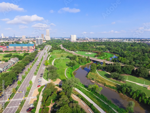 Aerial view of west-central area in Houston from Buffalo Bayou Park. Foreground is historic Fourth Ward, Allen Parkway, Memorial Parkway, Buffalo Bayou river, mid-town high-rise buildings in distance photo