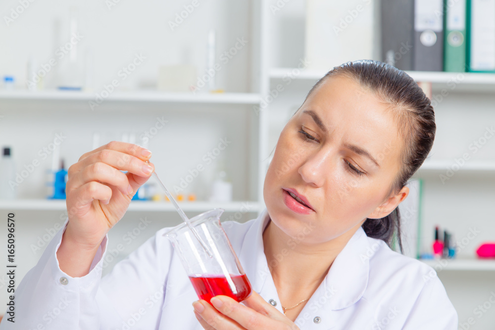 Young female scientist in lab , doing experiments in lab. Young female scientist in lab , doing experiments in lab.