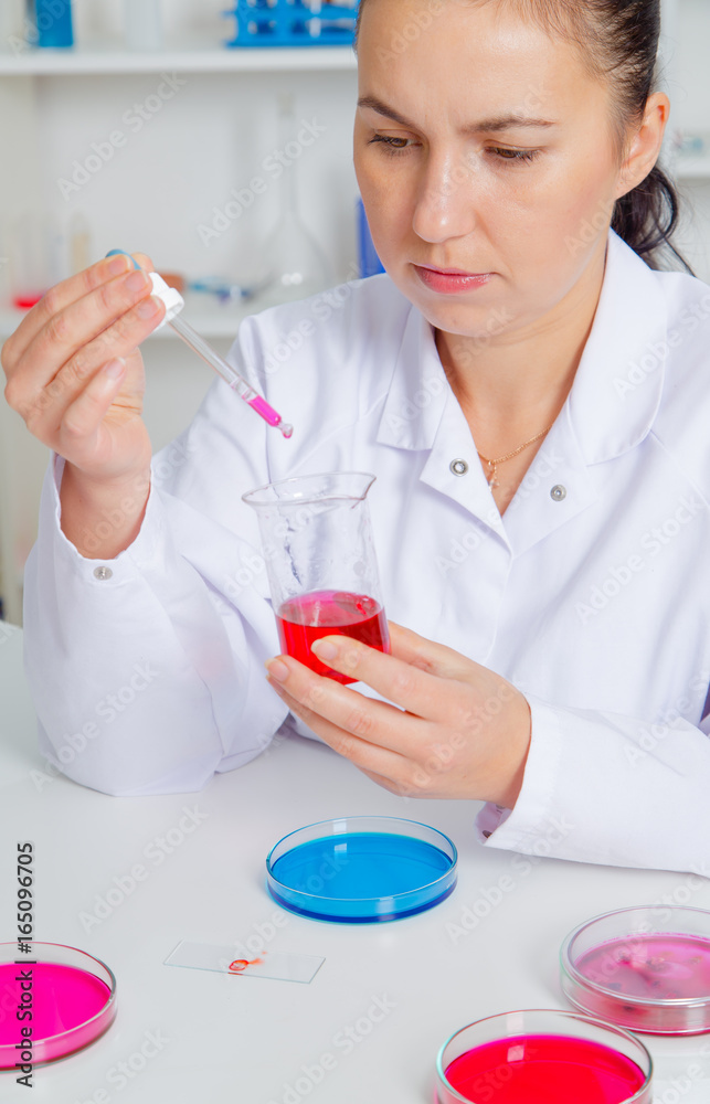 Young female scientist in lab , doing experiments in lab. Young female scientist in lab , doing experiments in lab.