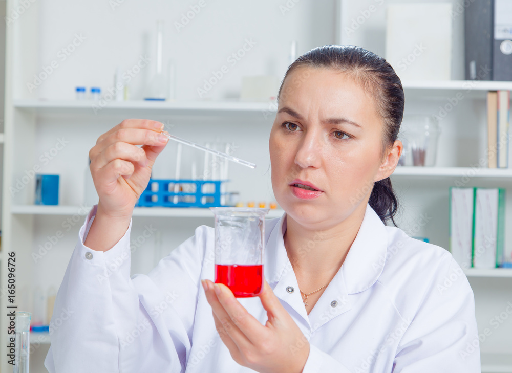 Young female scientist in lab , doing experiments in lab. Young female scientist in lab , doing experiments in lab.