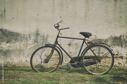The bike retro vintage with old cement wall as a background.