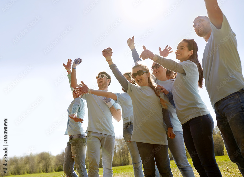 group of volunteers celebrating success in park
