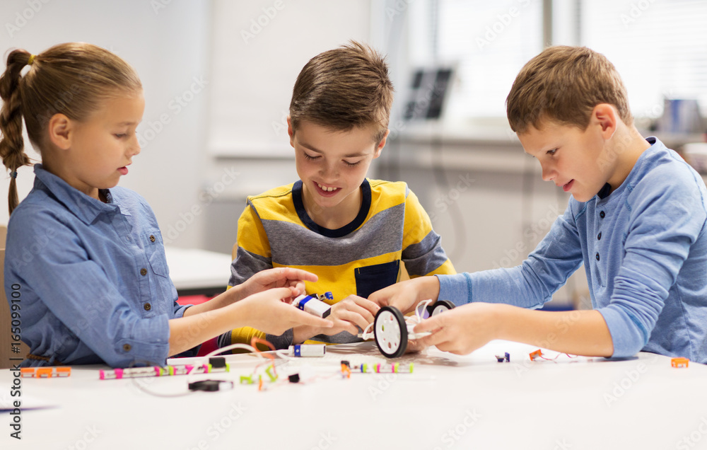 happy children building robots at robotics school happy children building robots at robotics school