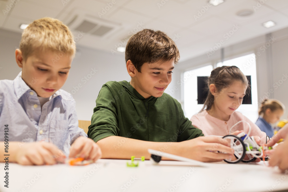 happy children building robots at robotics school happy children building robots at robotics school