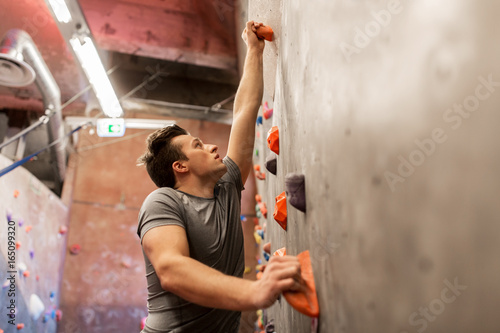 young man exercising at indoor climbing gym