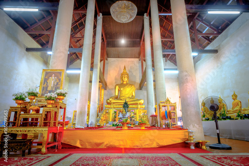 Golden buddha statue in the old church Wat Samanakotaram in Ayutthaya historical park, Thailand. . photo