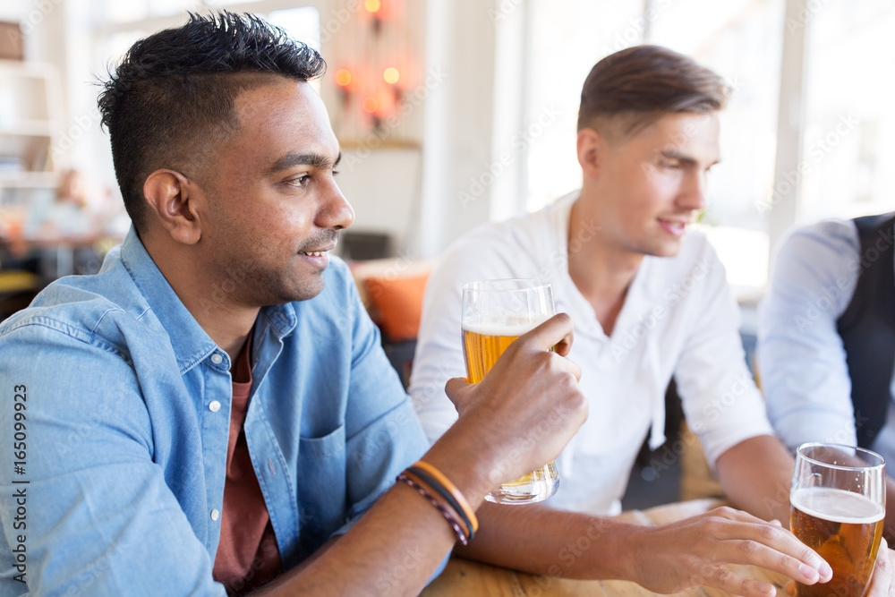 happy male friends drinking beer at bar or pub happy male friends drinking beer at bar or pub