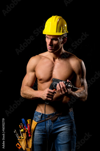 fit shirtless worker with drill and tools