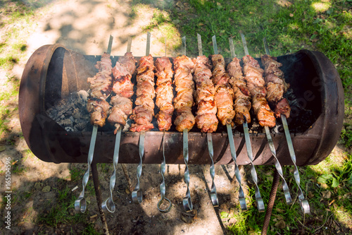 Bild auf Leinwand Sven shashlik closeup mashed slices of meat put on metal skewers roasted on char