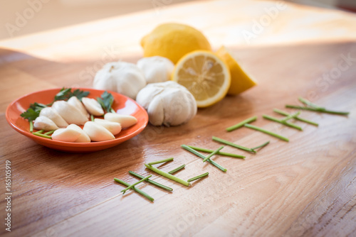 Mix of vegetables garlic lemon and parsley on a table for preparing healthy diet receipt
