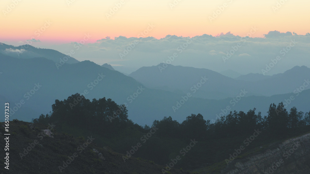High panorama view of mountains and clouds in the morning during orange sunrise.