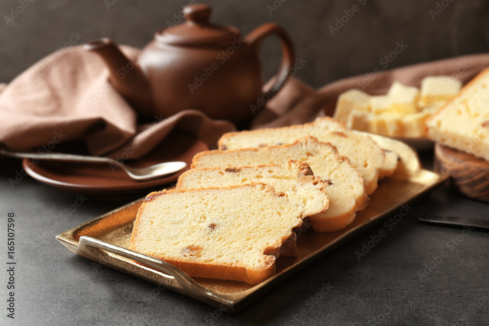 Tray with delicious sliced butter cake on table Tray with delicious sliced butter cake on table
