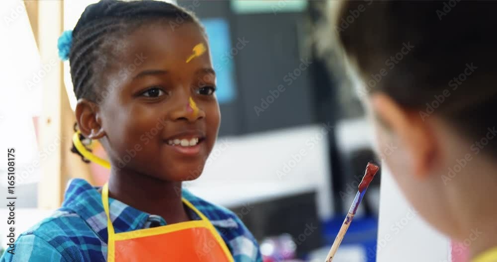 Schoolkids interacting with each other during drawing class