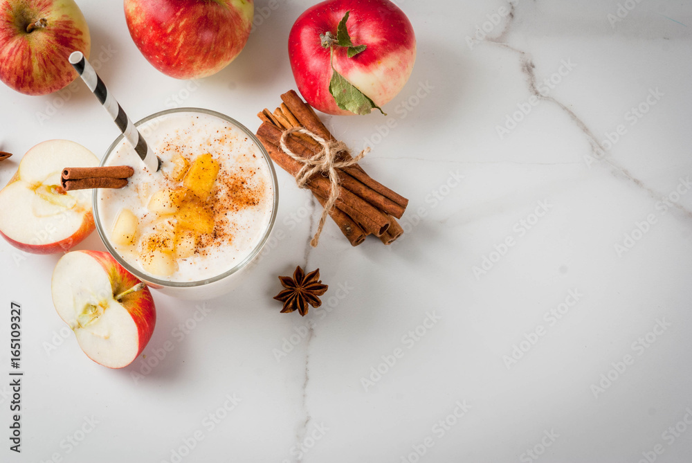 Healthy vegan food. Dietary breakfast or snack. Apple pie smoothies, with apples, yogurt, cinnamon, spices, walnuts. In a glass, on a white marble table. Copy space top view