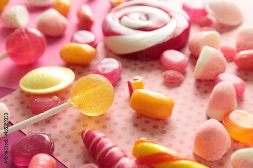 Tasty candies on color background, closeup