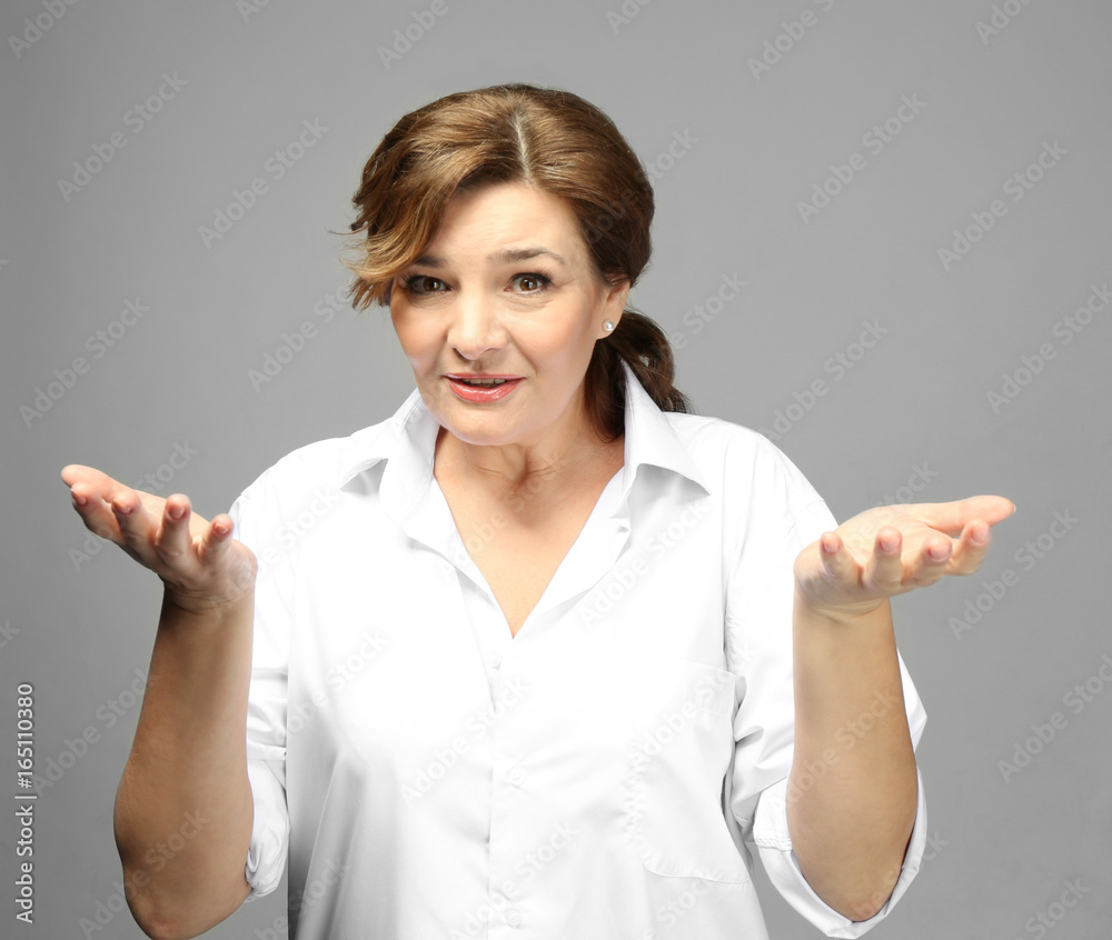 Beautiful elderly woman posing on light background Beautiful elderly woman posing on light background