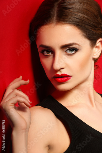 Beautiful young woman with bright lips on color background  closeup