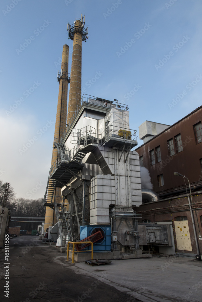Fototapeta premium Two industrial chimneys with yellow brick