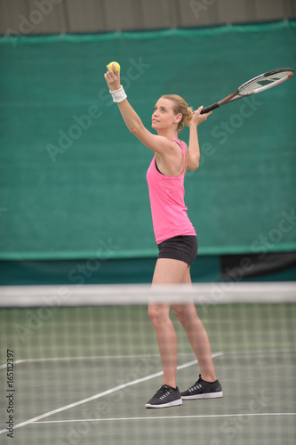 Woman serving at tennis