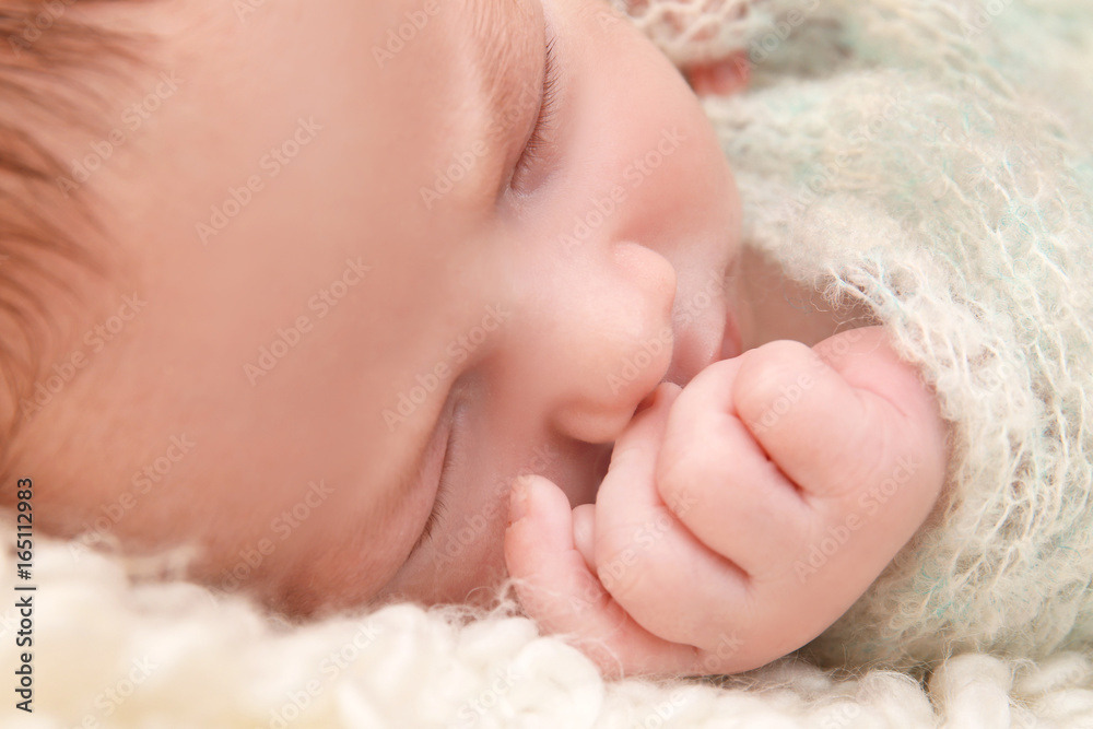 Sleeping newborn baby boy on soft plaid at home Sleeping newborn baby boy on soft plaid at home