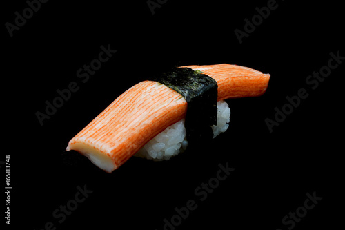 Kani sushi or Crab stick top on rice rap by Seaweed. Japanese tradition food withe black isolated background