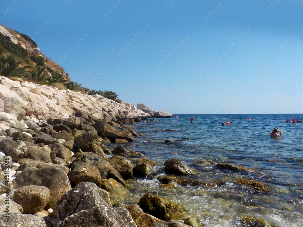 Spanish coast. Peñon de Ifach stony beach, Calpe, Spain Spanish coast. Peñon de Ifach stony beach, Calpe, Spain