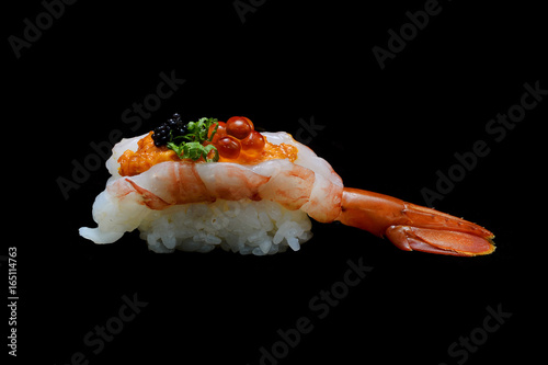 Botan ebi sushi or Spacial premium king shrimp sushi mixed by ikura and caviar top on Japanese rice. Japanese tradition food with black isolated background