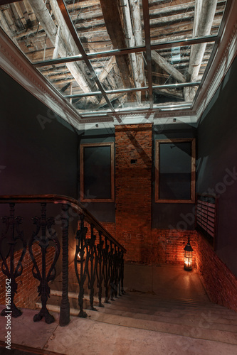 Modern industrial creative workspace. staircase with textured brick walls to the attic loft