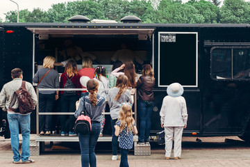 food van truck. group of people customers at mobile van with burgers and bbq at street food festival. food truck with snacks and drinks at eating market