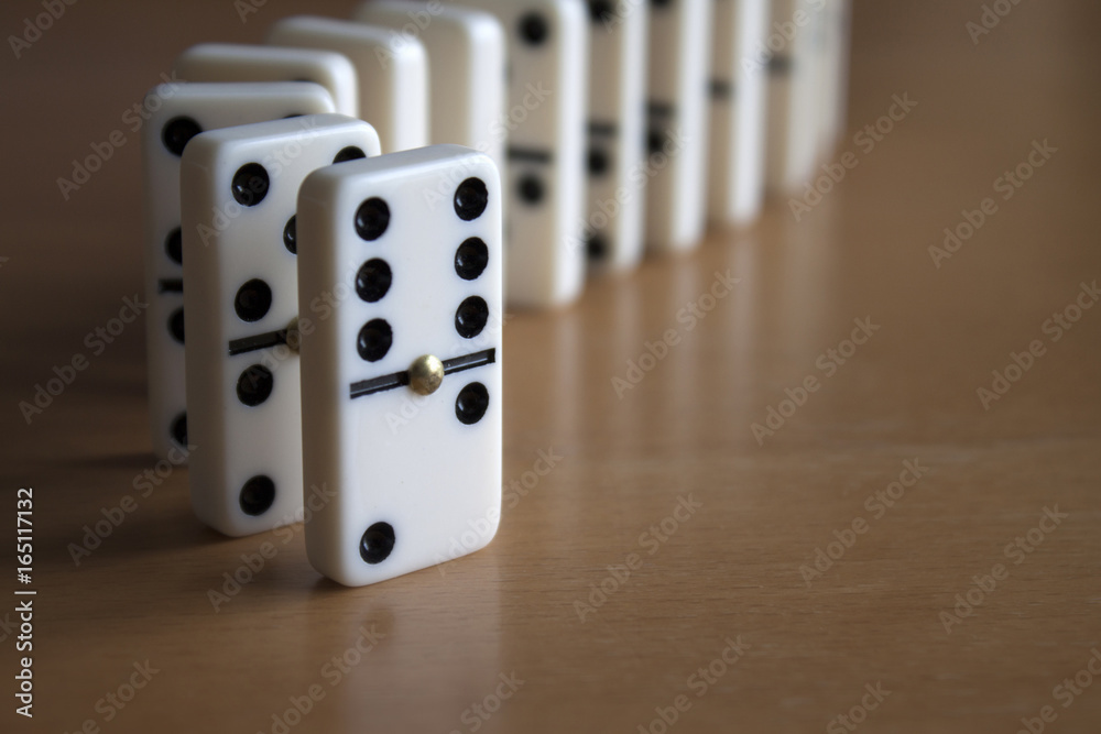 Domino Tiles Standing in Line on Wooden Table Domino Tiles Standing in Line on Wooden Table
