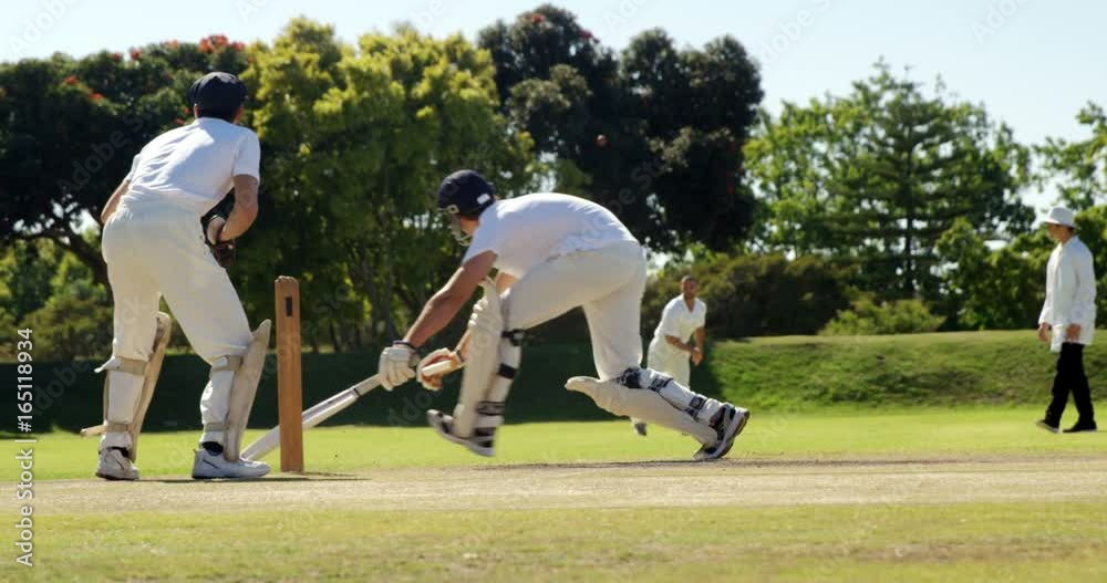 Fielder throwing ball to wicket keeper during cricket match