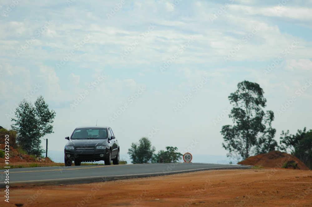 lonely car on top of hill on small road lonely car on top of hill on small road