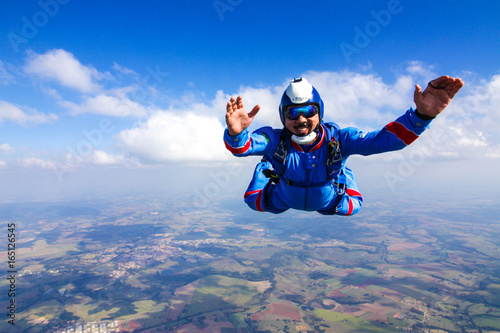 Happy parachutist in free fall