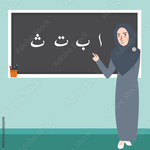 teacher female standing in front of class explain Arabic alphabet learn Islam scripture