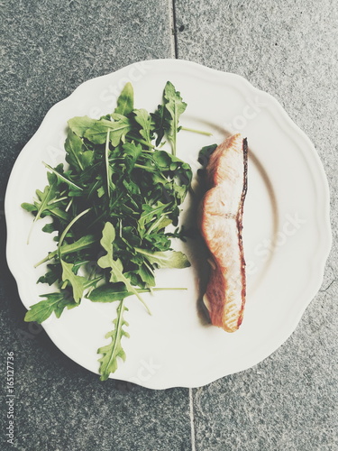 Salmon and rucola arugula rucolla  dish on white plate 