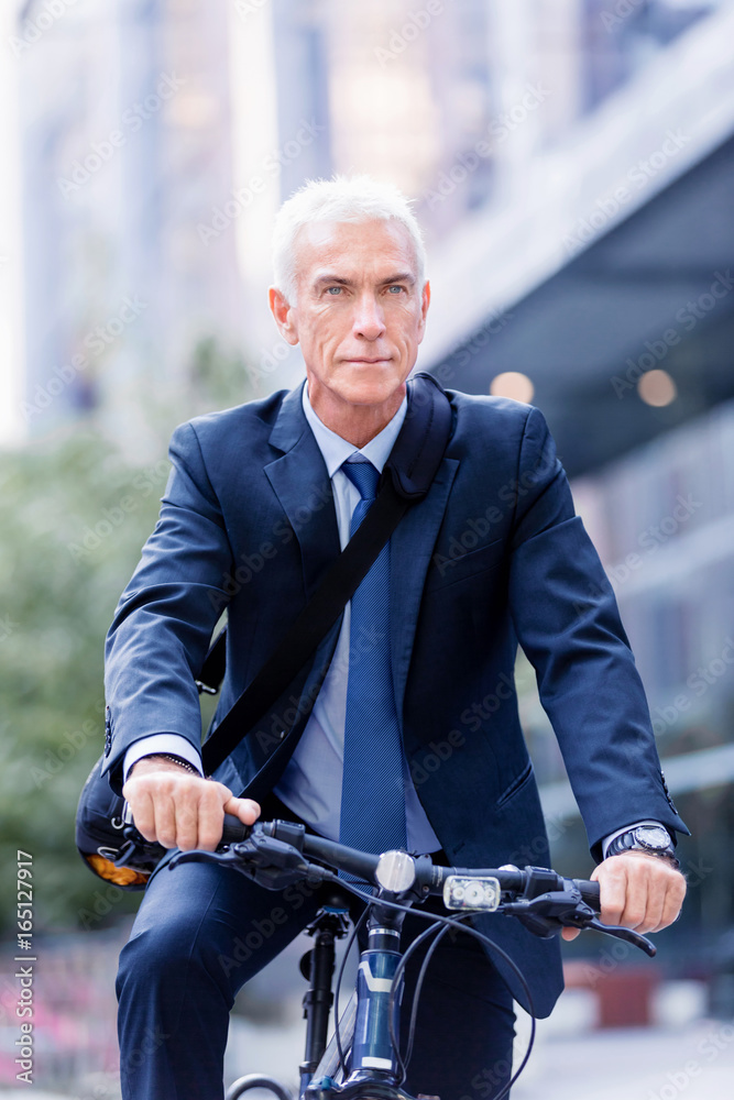 Fototapeta premium Successful businessman riding bicycle