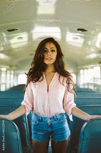 Young pretty woman on an empty bus photo