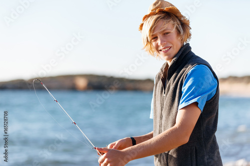 Teenage boy fishing at sea