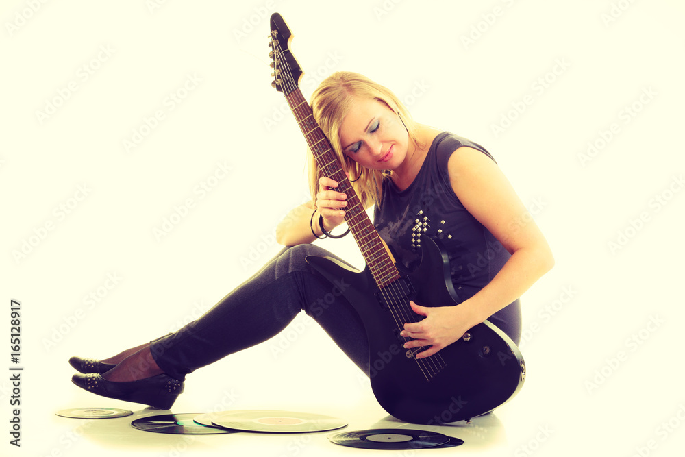 Woman with electrical guitar and vinyl record.