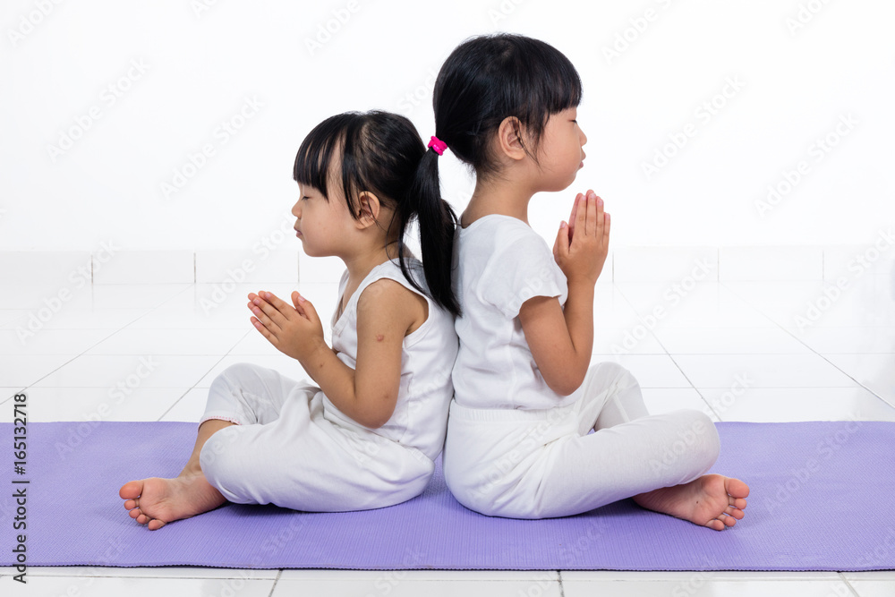Asian Chinese little girls practicing yoga pose Asian Chinese little girls practicing yoga pose