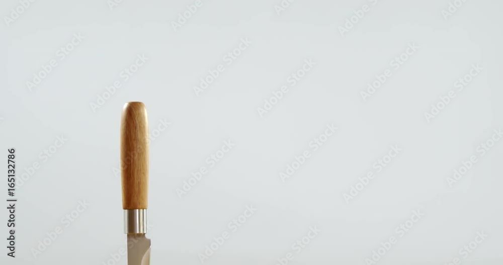 Halved mango and knife on wooden table Halved mango and knife on wooden table
