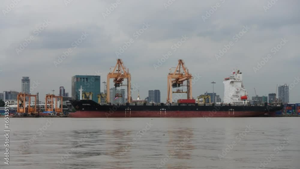 Time lapse. Container loading by crane, cargo ship at shipping port at twilight, Logistics and transportation concept Time lapse. Container loading by crane, cargo ship at shipping port at twilight, Logistics and transportation concept