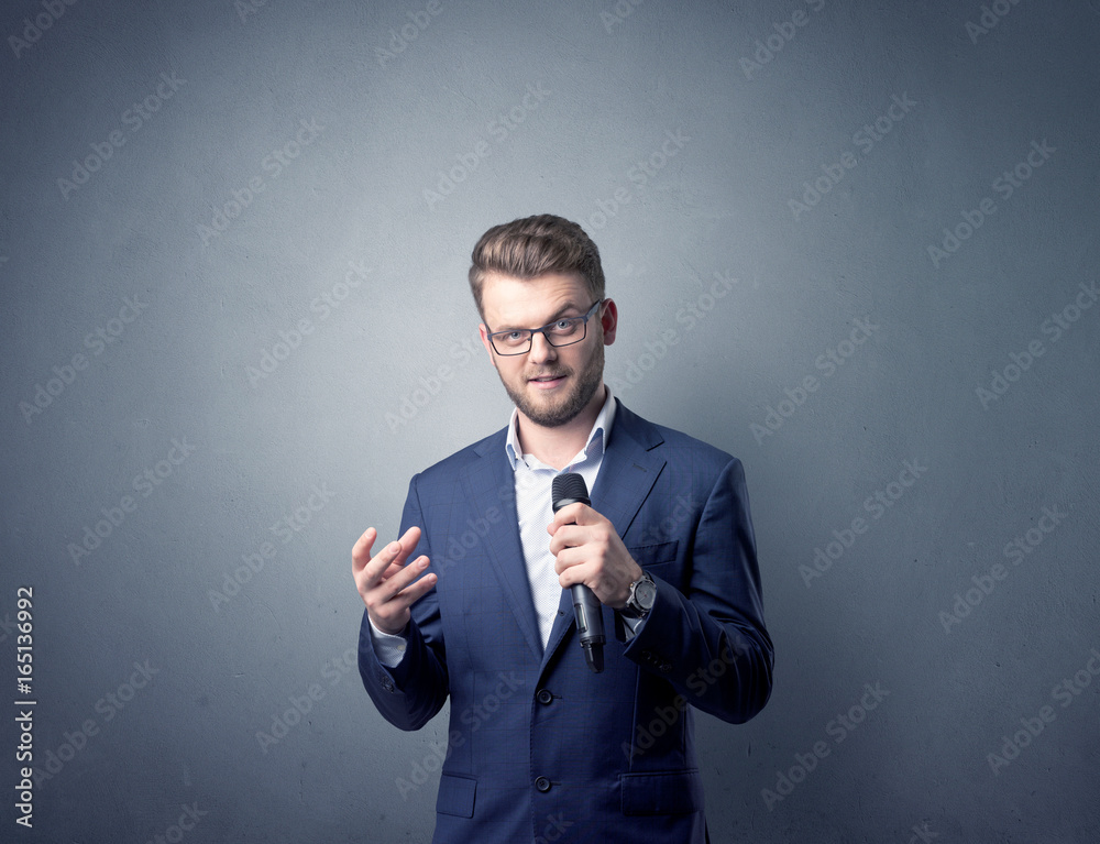 Businessman holding microphone Businessman holding microphone