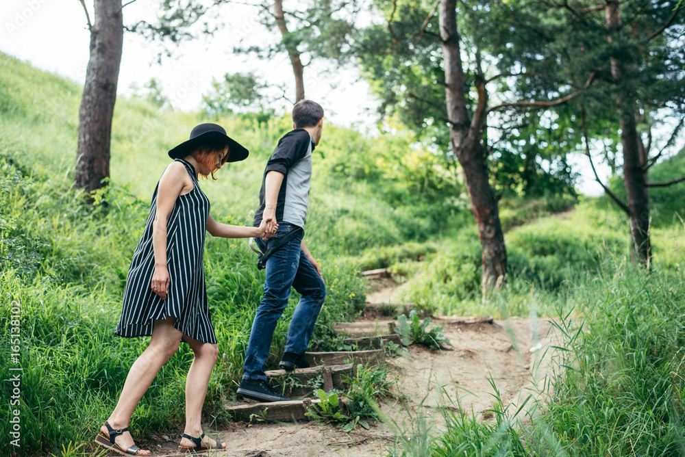 lovely couple climbing up by forest trail lovely couple climbing up by forest trail